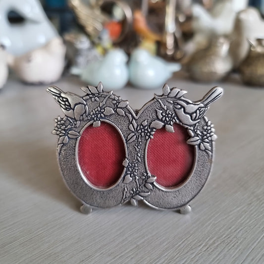 Small Mack English pewter double oval frame with flowers, perched birds and red velvet backing
