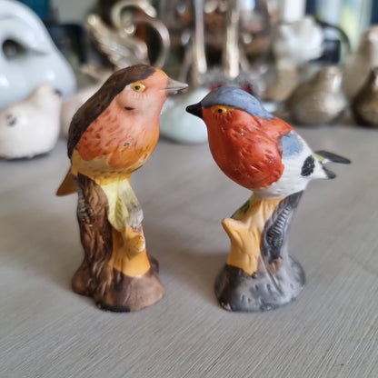 Hand-painted porcelain robin and chaffinch figurines perched on stumps