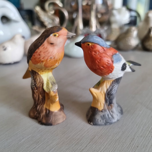 Hand-painted porcelain robin and chaffinch figurines perched on stumps