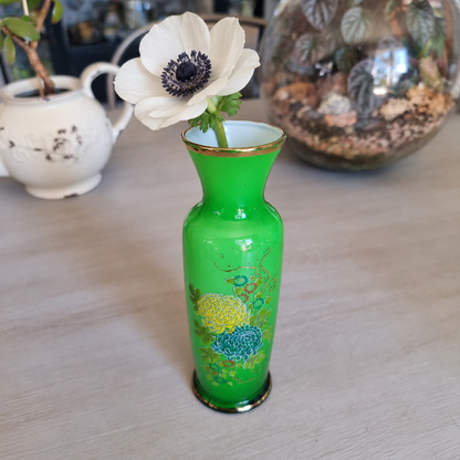 Vintage green floral glass vase with a gold rim holding a single ivory anemone